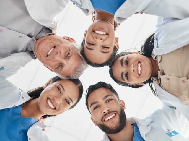 Shop of a group of medical practitioners standing together in a huddle.